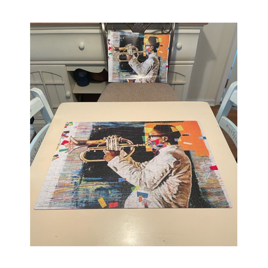Completed 18" x 24" jigsaw puzzle of jazz musician by artist Noland Anderson (copyright 2022) and poster
